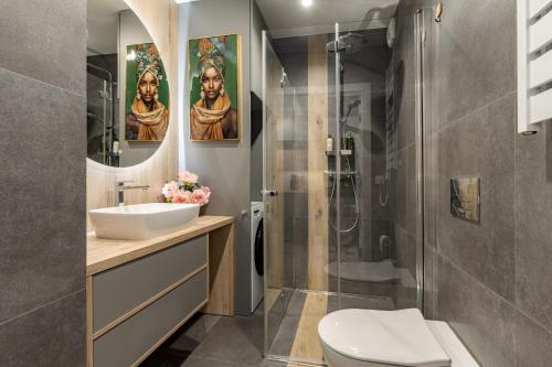 a bathroom with a sink and a shower at Apartament Sun&City in Bielsko-Biała