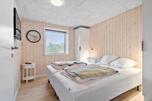 a bedroom with a large white bed with a window at 0180-Romo-Ejnar-Mikkelsensvej-8 in Høm