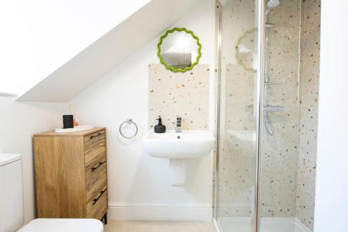 a bathroom with a sink and a shower at Quirky Apartment in Richmond, North Yorkshire in Richmond