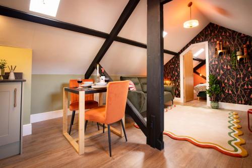a dining room with a table and orange chairs at Quirky Apartment in Richmond, North Yorkshire in Richmond