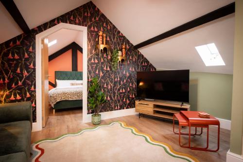 a living room with a tv and a bedroom at Quirky Apartment in Richmond, North Yorkshire in Richmond