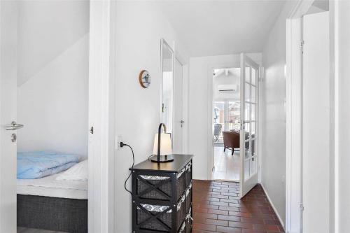 a bedroom with a bed and a table with a lamp at 0281-Romo-Vestergade-3-Ap-13 in Høm