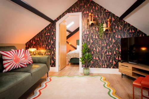 a living room with a couch and a tv at Quirky Apartment in Richmond, North Yorkshire in Richmond