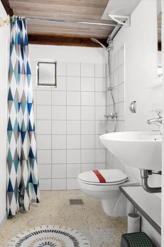 a bathroom with a toilet and a sink at 0418-Romo-Sonderstrandvej-19 in Høm