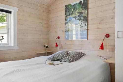 a bedroom with a bed with two pillows and a book at 0311-Romo-Strandskaden-10 in Høm