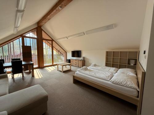 a bedroom with a bed and a desk in a room at Apartmány Humno in Stará Turá