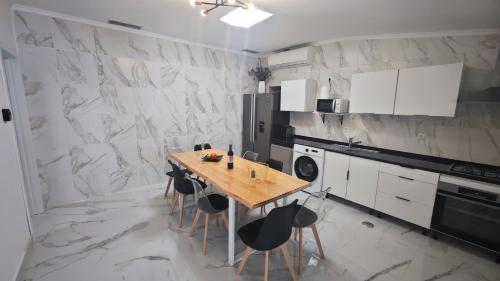 a kitchen with a wooden table and black chairs at Cascais garden hotel in Cascais