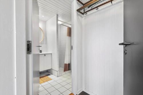 a bathroom with a walk in shower and a door at 0295-Romo-Vestergade-3-68-E in Høm