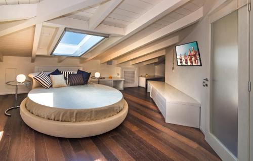 a bedroom with a large bed with a skylight at Il Forte di Monic in Forte dei Marmi