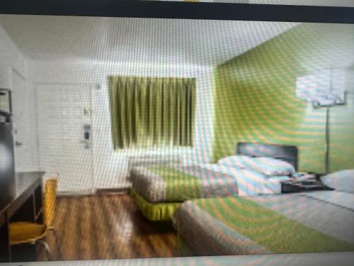 a hotel room with a bed and a couch at Motel 6 El Paso East in El Paso