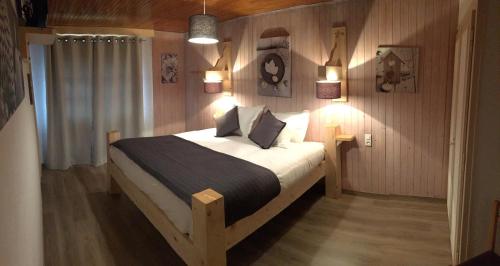 a bedroom with a large bed in a room at Relais Mont Jura Adults Only in Lélex