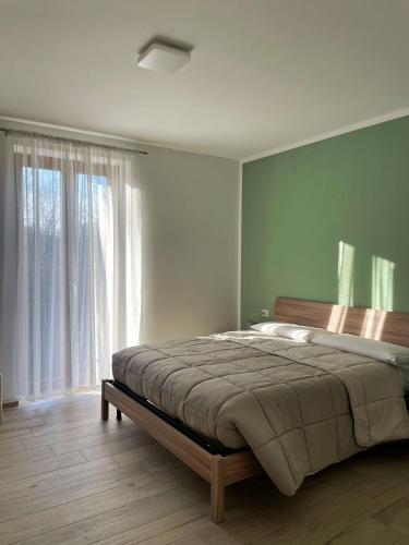 a bedroom with a bed and a large window at Antico Ticino Malpensa in Lonate Pozzolo