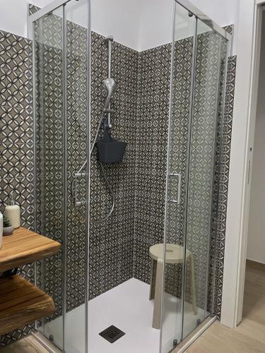 a shower stall with a stool in a bathroom at Antico Ticino Malpensa in Lonate Pozzolo
