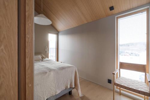 a bedroom with a bed and a large window at Joiku A1 Luxury Chalet in Kolari