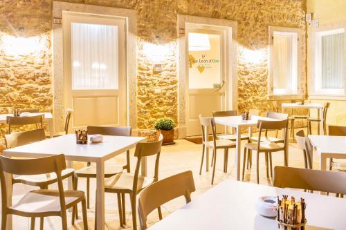 a restaurant with tables and chairs in a room at Casa Leon d'Oro in Bosco Chiesanuova