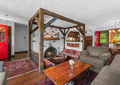 a living room with a fireplace and a couch and a table at Smugglers Trove a Mountain Adventure Getaway in Cambridge