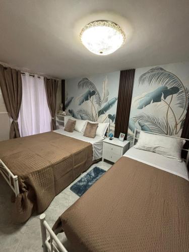 a bedroom with two beds and a mural of dolphins at Casa Concettina in Naples