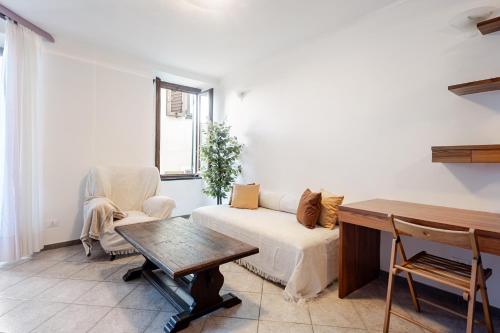 a living room with a couch and a table at Stylish & Colorful Open Space - Sleeps 5 in Manarola