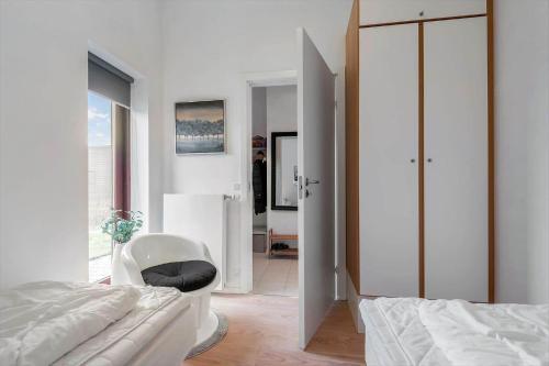a white bedroom with a bed and a white closet at 0349-Romo-Vestergade-301 in Høm