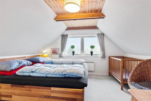 a bedroom with a bed and a window at 0315-Romo-Dyssebjergvej-49 in Høm