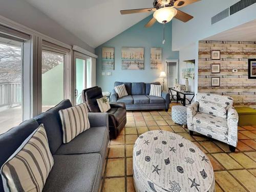 a living room with a couch and a ceiling fan at Cozy Coastal Repose in Padre Island