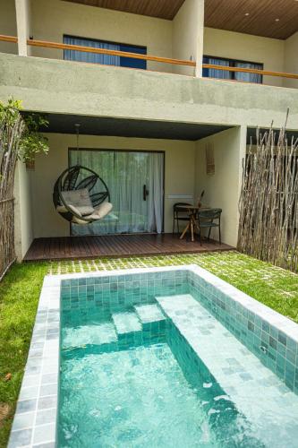a swimming pool in the backyard of a house at Pousada Noah Noah Milagres in São Miguel dos Milagres