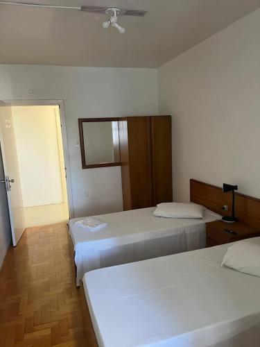 a hotel room with two beds and a window at City Hotel PF in Passo Fundo