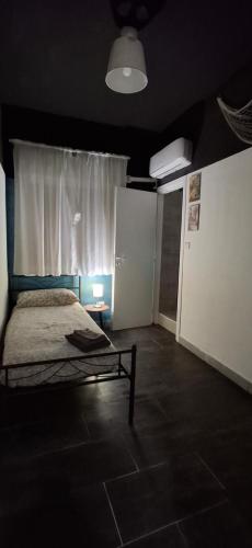 a bedroom with a bed and a window and a door at B&B RELAX in Messina