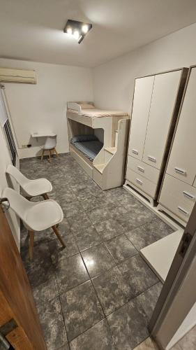 a room with a bed and a table and chairs at Dúplex Premium Cañada!! in Cañada de Gómez