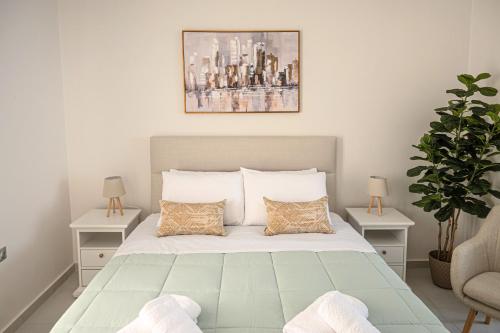 a bedroom with a bed with two tables and a plant at Noméa - Modern Apartment Aigio in Aigio