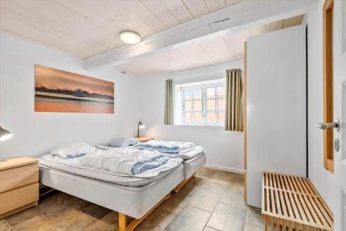 a bedroom with a bed and a window at 0499-Romo-Vestergade-29 in Høm