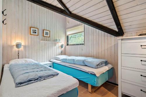 a bedroom with two beds and a window at 0161-Romo-Ejnar-Mikkelsensvej-4 in Høm
