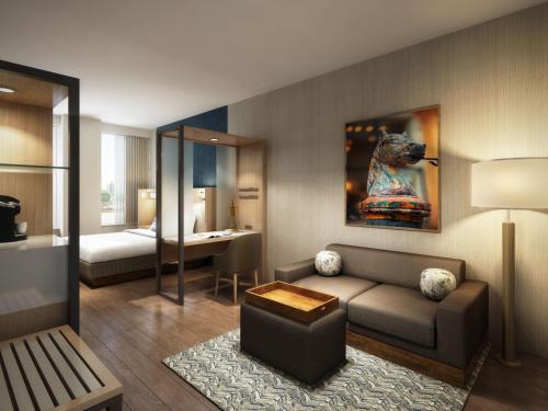 a living room with a couch and a bedroom at SpringHill Suites by Marriott New Orleans Downtown/Canal Street in New Orleans