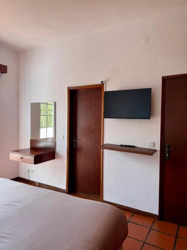 a bedroom with a bed and a door and a window at Habitación con terraza privada y vista a Funchal in Estrela