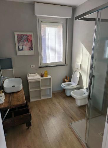 a bathroom with a shower and a toilet and a sink at Kaspers home lake Como in Blevio