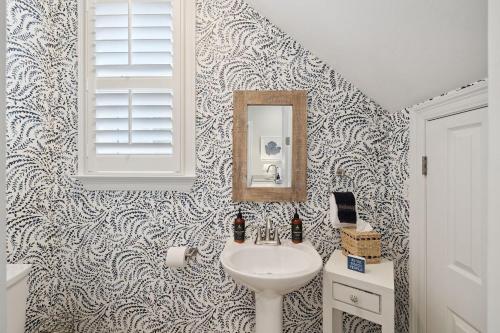 a bathroom with a sink and a mirror at Sweet Bay on 30A in Seagrove Beach