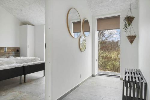 a bedroom with a bed and a mirror on the wall at 0364-Romo-Vestergardsvaenget-7 in Høm