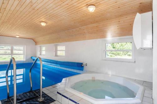 a large bathroom with a large tub in it at 2005-Romo-Thadesvej-14 in Høm