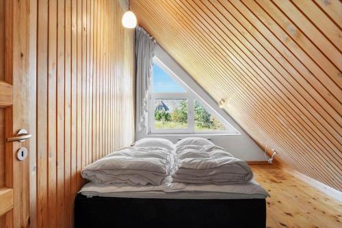 a bed in a room with a window at 2005-Romo-Thadesvej-14 in Høm