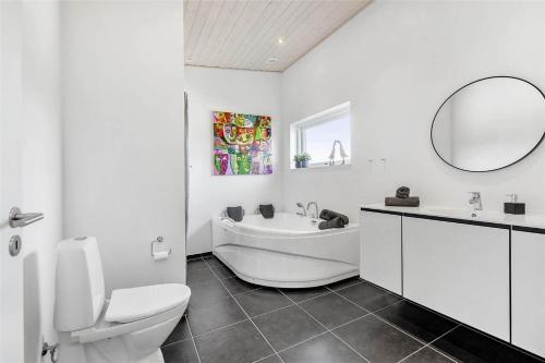 a bathroom with a tub and a toilet and a sink at 0323-Romo-Vestergade-359 in Høm