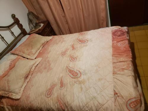 a bed with a red and white blanket on it at DaKa in San Bernardo