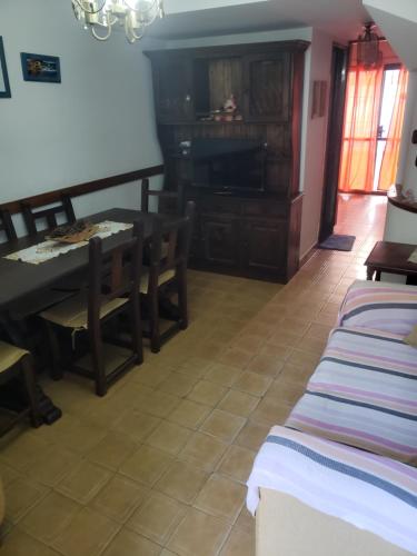 a living room with a table and chairs and a piano at DaKa in San Bernardo