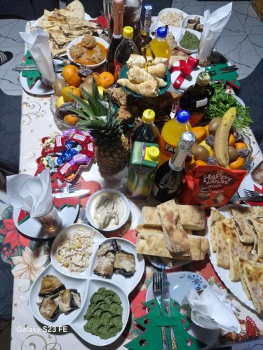 a table with a bunch of different types of food at Maia's Guesthouse in Mestia