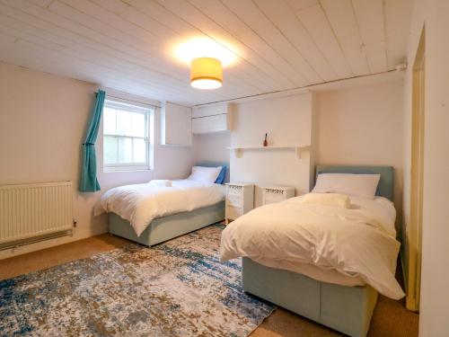 a bedroom with two beds and a window at 7 Athol Terrace in Dover