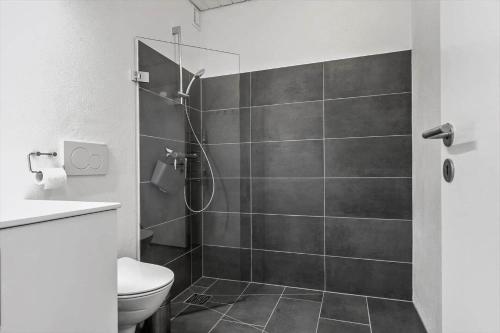 a bathroom with a shower and a toilet at 0459-Romo-Vestergade-237-App-64 in Høm