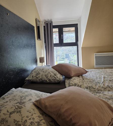 a bedroom with two beds and a window at Grand Gite Angelique avec Jardin - Centre Ribeauvillé in Ribeauvillé