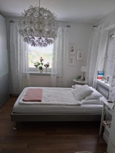 a bedroom with a large bed and a chandelier at Villa Siegrid in Kremsmünster