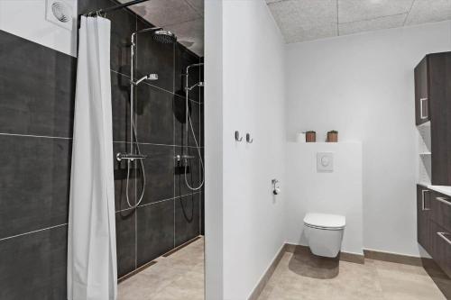 a bathroom with a shower and a toilet at 2007-Romo-Juvrevej-43 in Høm