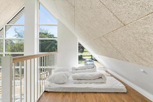 a white room with two beds on a staircase at 2007-Romo-Juvrevej-43 in Høm