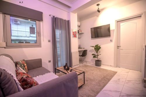 a living room with a couch and a tv at live it _ Karditsa in Karditsa
